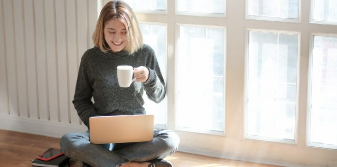 woman-in-gray-sweater-drinking-coffee-3759089