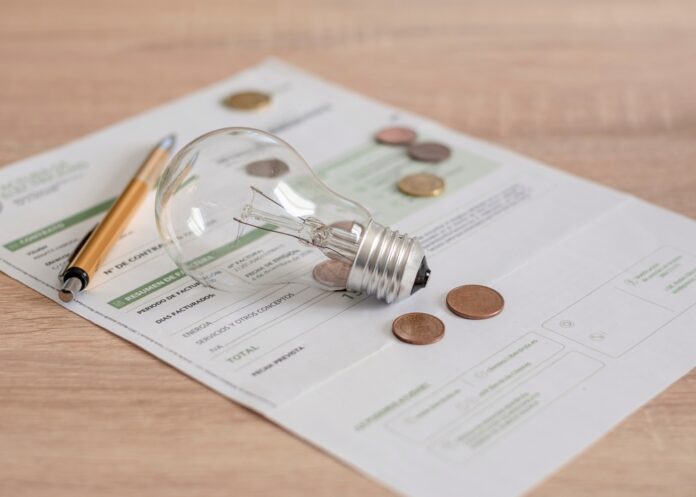 Electricity,Bill,With,Light,Bulb,,Several,Coins,And,Pen,On Save on energy bills